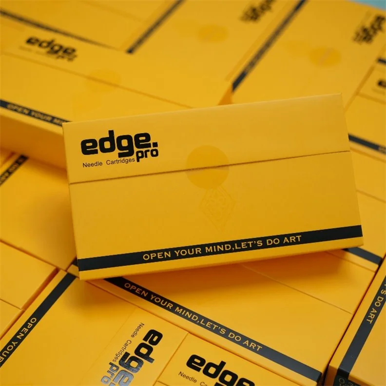 Gestapelte gelbe Edge Pro Verpackungen, die obere mit dem Aufdruck edge.pro Needle Cartridges und Open Your Mind Let's Do Art